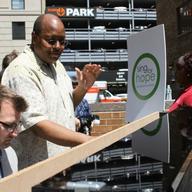 Pianist Brian Neff plays while New York City Housing Authority Youth Chorus director Larry Matthew conducts and turns pages.